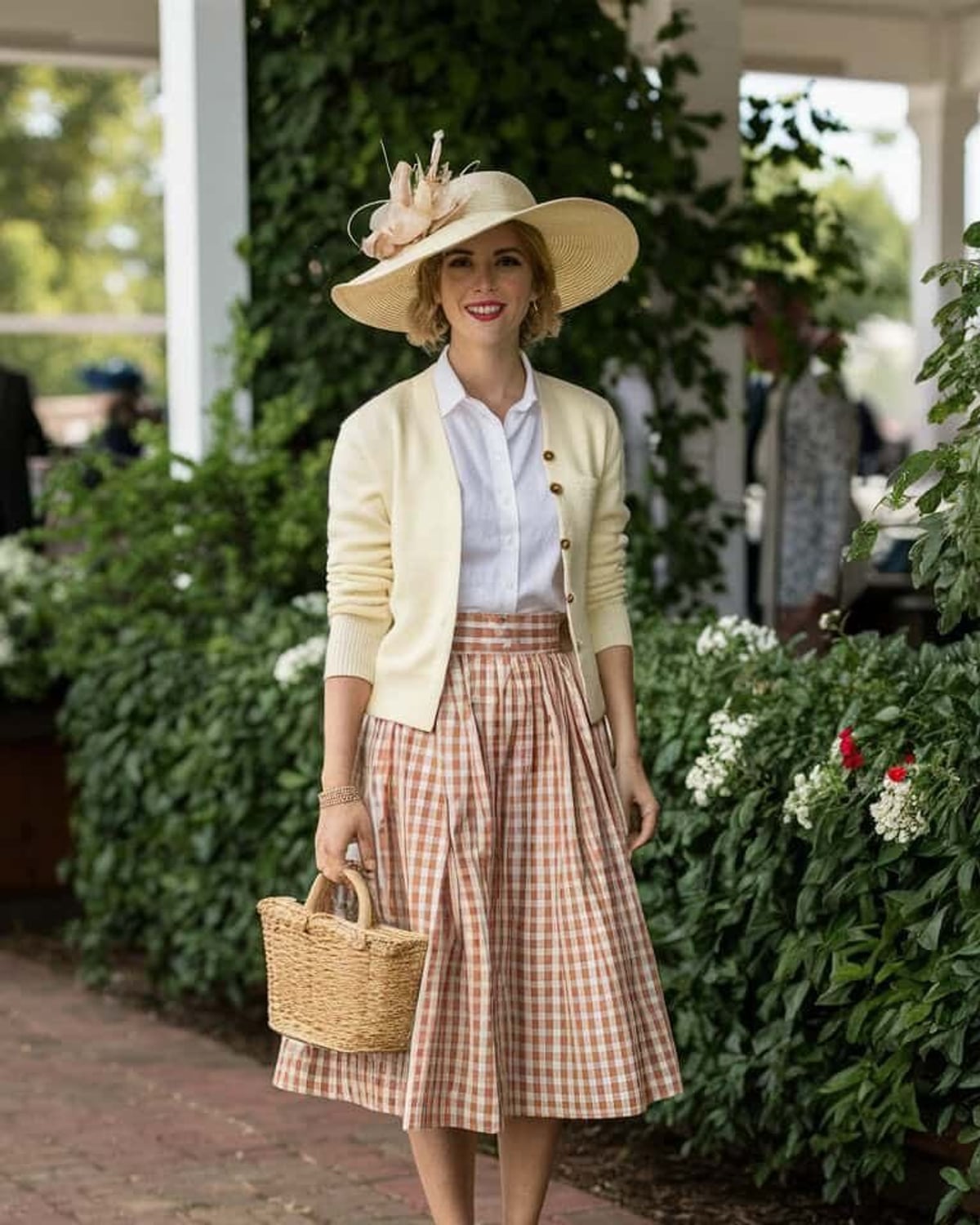 Charleston Genteel outfit — wide-brim straw hat with floral trim, cream button-front cardigan, white oxford button-down shirt, gingham pleated midi skirt, woven straw basket bag