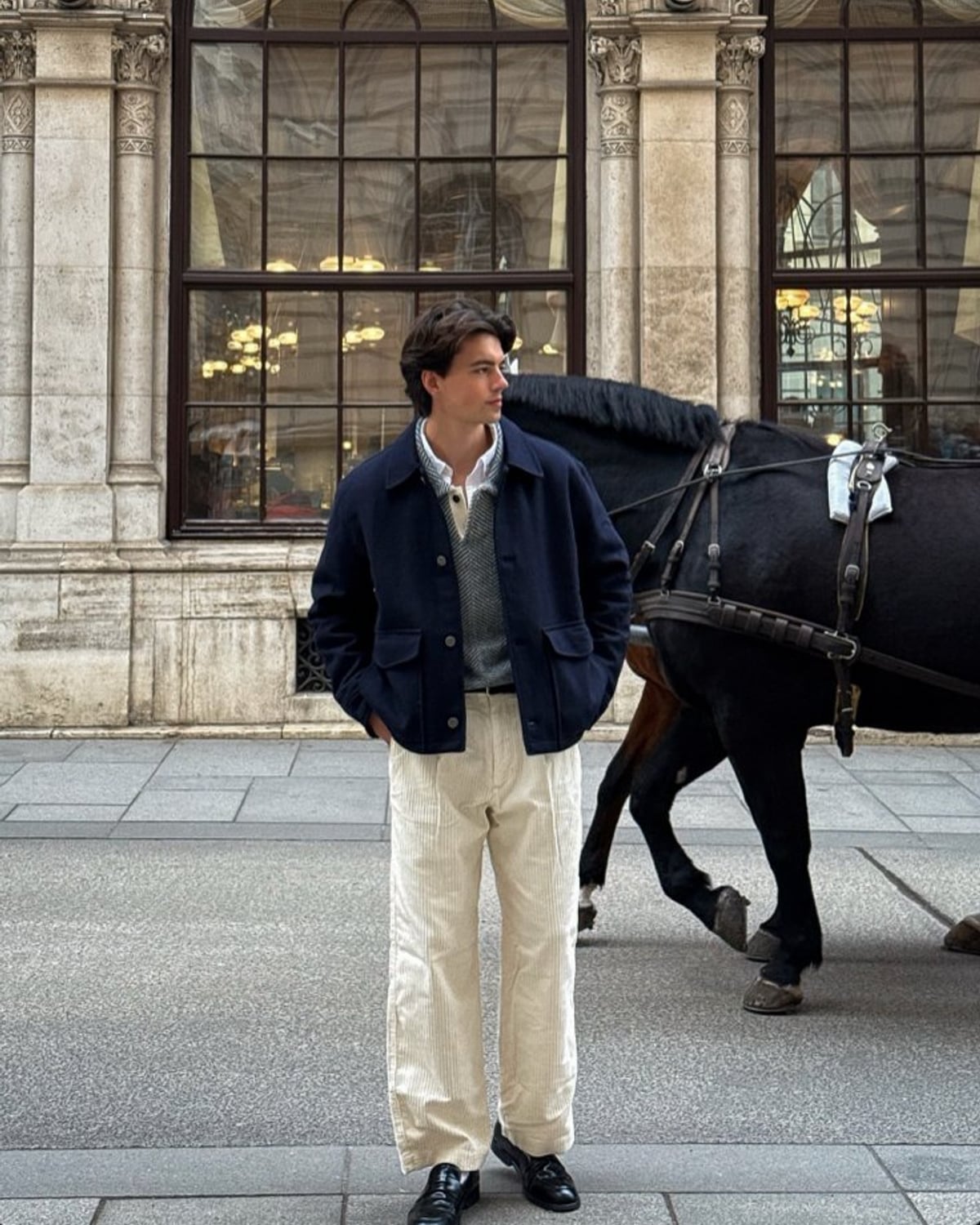Copenhagen Scandi outfit — men's navy wool chore jacket, men's gray V-neck knit sweater, men's white oxford button-down shirt, men's cream corduroy wide-leg trousers, men's black leather loafers