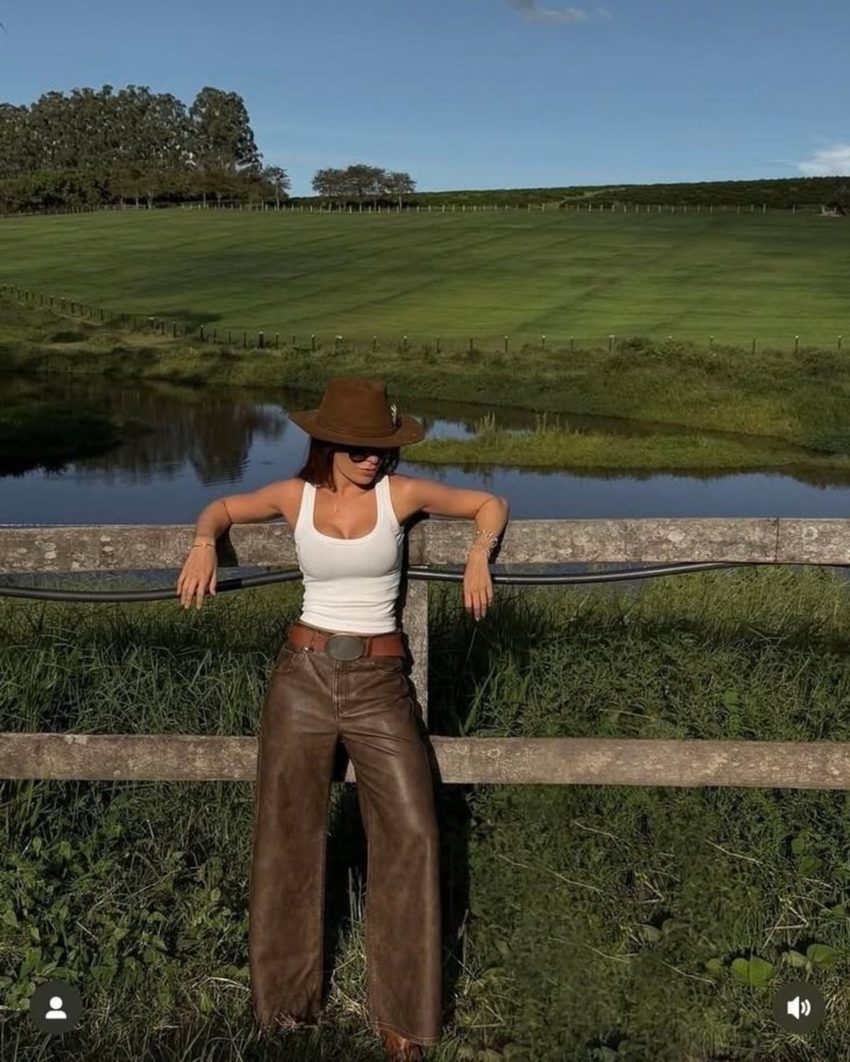 Texas Western Revival outfit — Brown felt cowboy hat, Tortoise sunglasses, White ribbed tank top, Tooled leather belt with silver buckle, Brown leather wide-leg pants